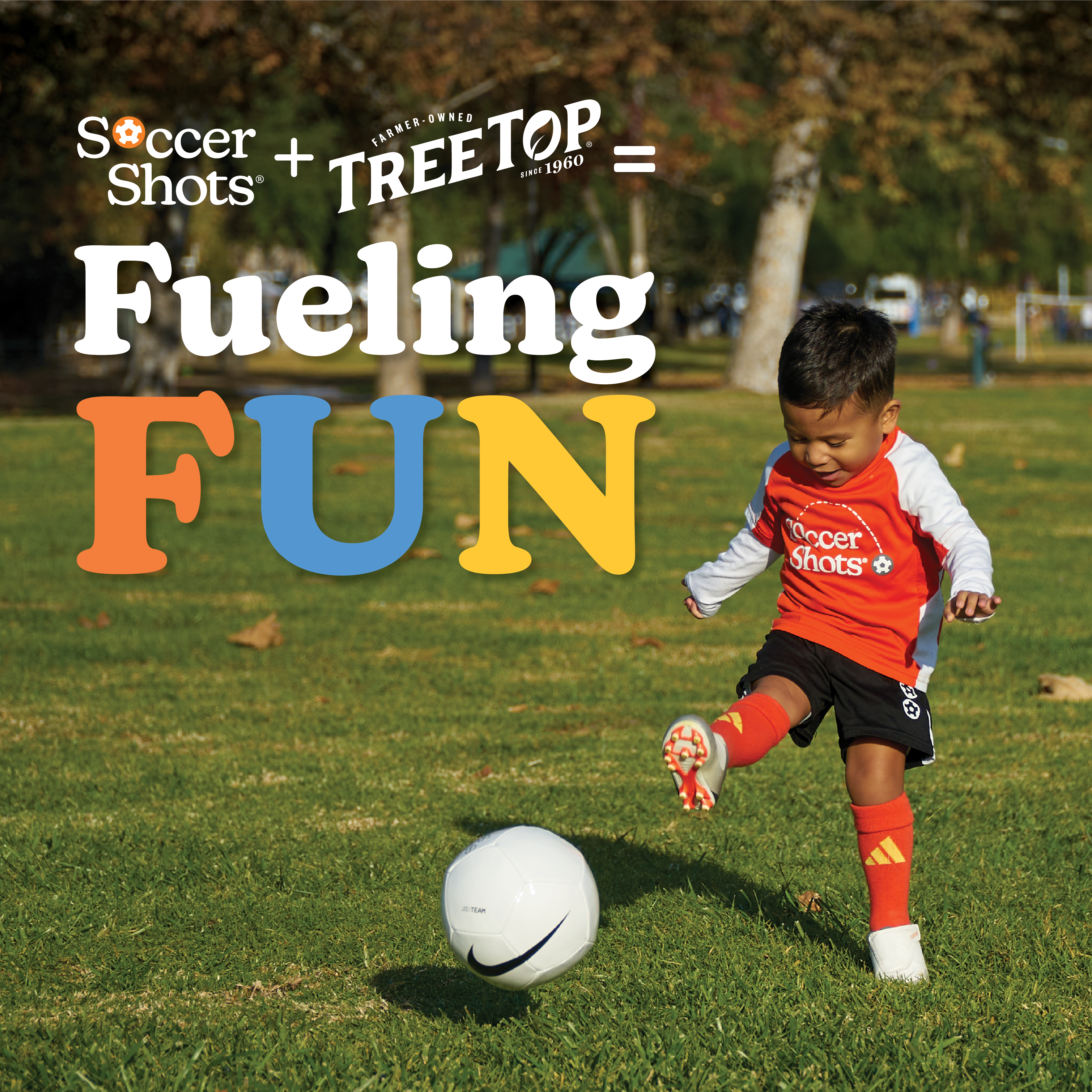 Child kicking a soccer ball in a Soccer Shot jersey.
